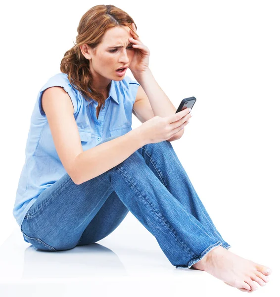 Breakups are hard to take - Relationships. Beautiful young woman reading a text message in disbelief. Stock Photo