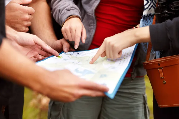 Eles se aventuraram fora do caminho batido. Vista cortada de um grupo de amigos segurando um mapa e procurando direções. — Fotografia de Stock