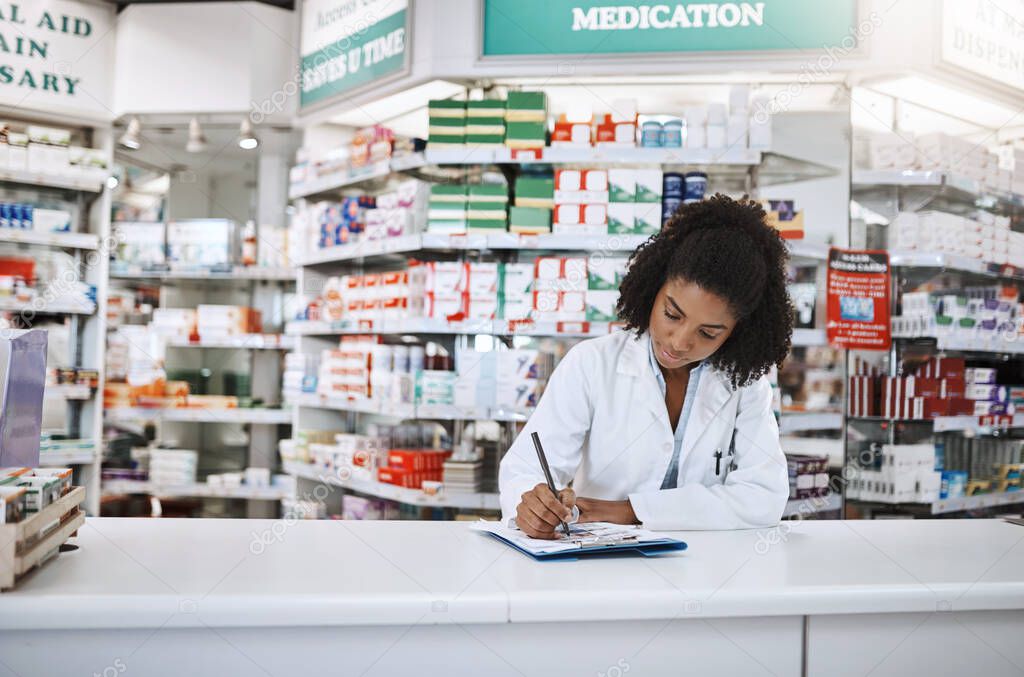Ill leave you some instructions. Cropped shot of an attractive young female pharmacist working in a pharmacy.