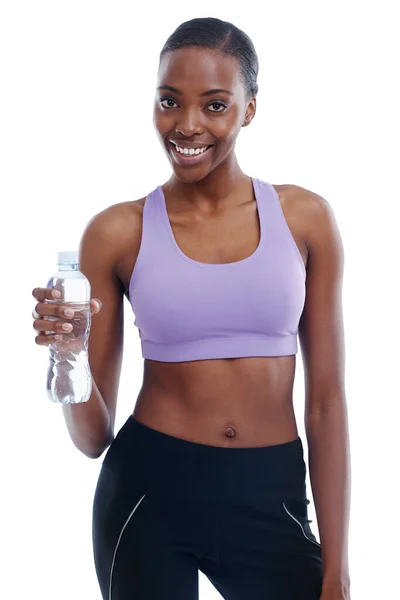 Water - an important part of my workout. An isolated portrait of a sporty young woman holding a bottle of water. — Stock Photo, Image