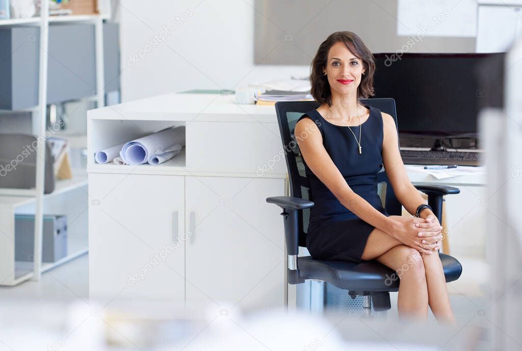 Ready to achieve even greater success. Portrait of a young designer sitting at her workstation in an office.