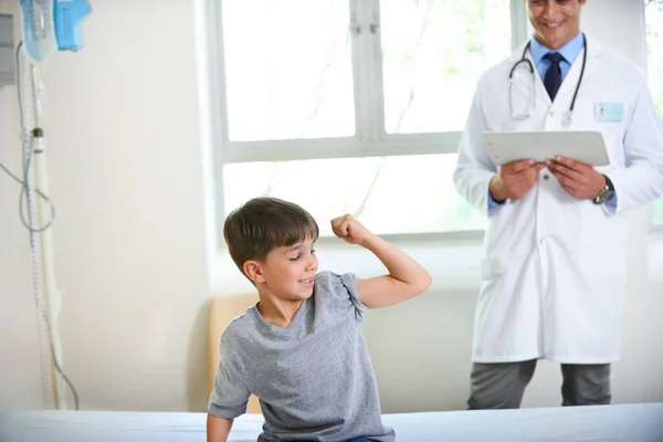 Beobachten Sie meine Muskeln wachsen doc. Aufnahme eines kleinen Jungen, der seine Stärke und Tapferkeit zeigt, indem er seinen Arm beugt. — Stockfoto