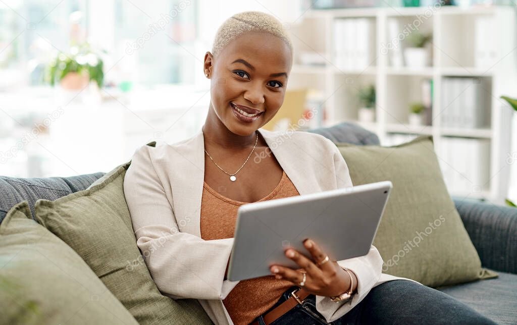 Technology pushes me further towards my goals. Portrait of a young businesswoman using a digital tablet in an office.