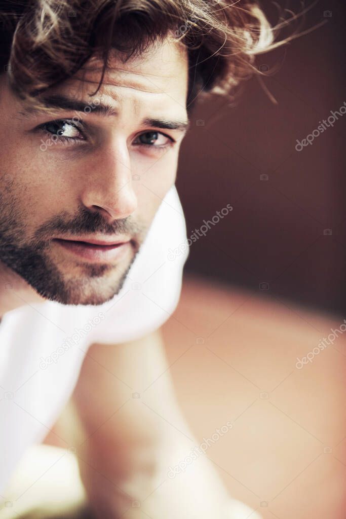 You could get lost in his eyes. Handsome young male looking at you with warm brown eyes.