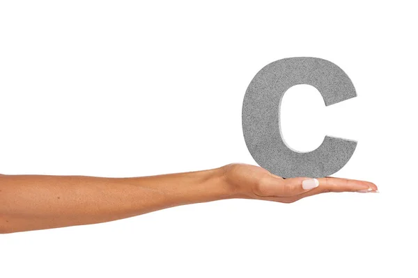 C what I did there.... A young woman holding a capital letter C isolated on a white background. — Stock Photo, Image