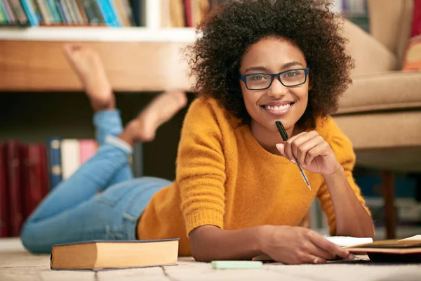 L'inglese è la mia materia preferita. Ritratto a figura intera di una giovane donna sdraiata sul pavimento mentre studia. — Foto Stock