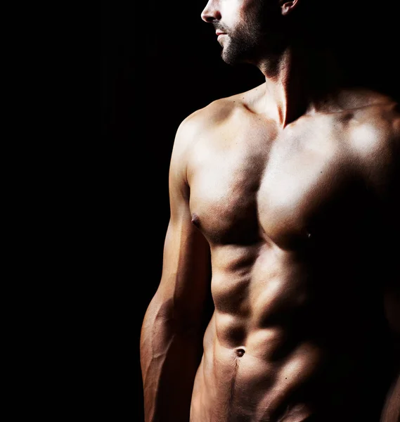 Masculinity in portrait. Studio shot of a muscular shirtless man isolated on black. — Stock Photo, Image