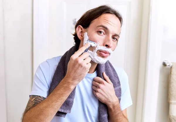 The ladies love a smooth face. Shot of a young man shaving his face in the morning. — Stock Photo, Image
