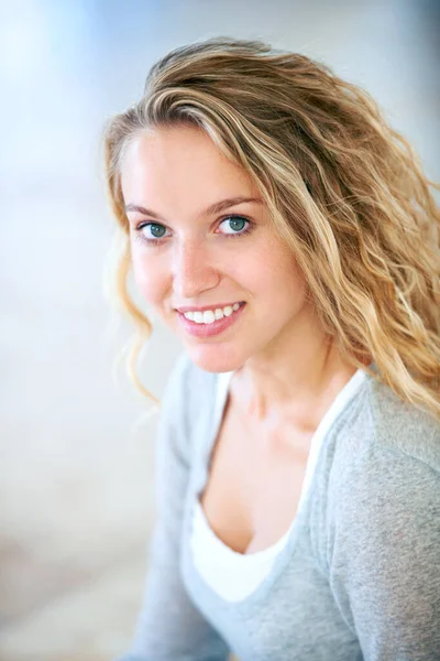 Sweet-natured and beautiful. Portrait of a pretty young blonde smiling at you sweetly. — Stock Photo, Image