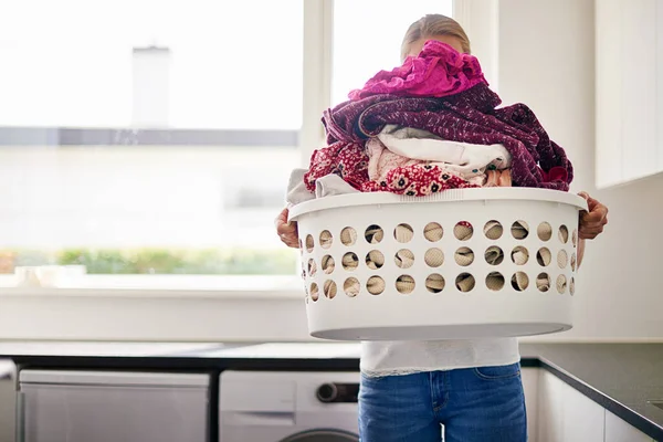 Its laundry day. Cropped shot of young woman doing laundry at home. — Stock Photo, Image