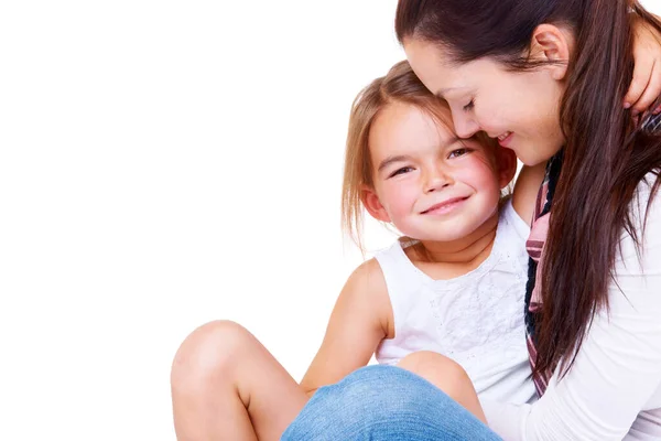 Mother-daughter relationships. Portrait of a cute little girl sitting in her mothers arms. Royalty Free Stock Images