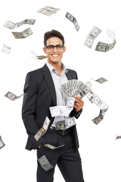 La medida del éxito. Retrato de un joven empresario sosteniendo efectivo mientras el dinero cae a su alrededor. —  Fotos de Stock