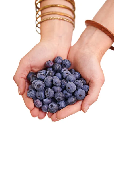 Handful of freshness. Cropped studio shot of a bunch of blueberries in a persons cupped hands. — Stock Photo, Image