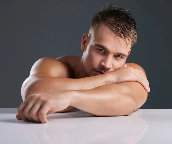 What a hunk. Studio portrait of a handsome and hunky young man posing in studio against a gray background. — Stock Photo, Image