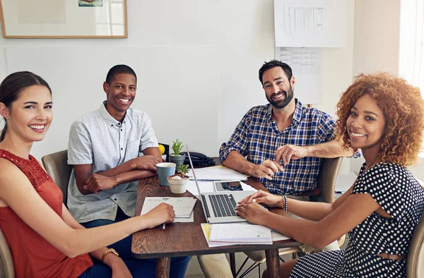 Theyre success comes with teamwork. Portrait of a group of colleagues working together at a desk in an office. — Stock Photo, Image