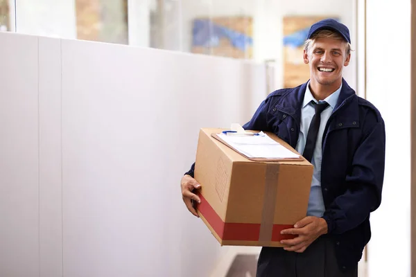 For reliable and reputable delivery Im your guy. Portrait of a confident young courier making a home delivery. — Stock Photo, Image