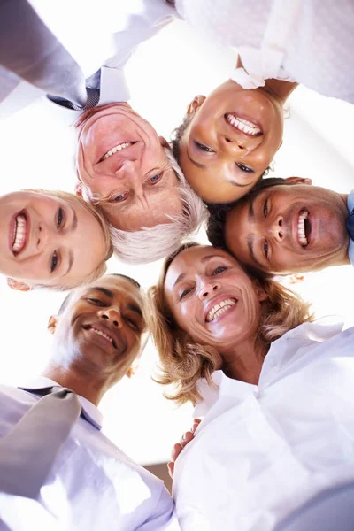 Working towards same goal. Low angle view of multi racial business team in huddle at office. — Stock Photo, Image