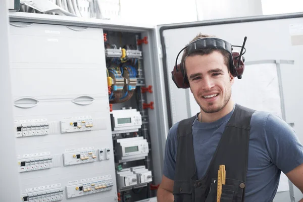 His electrical expertise will get the job done. Young contractor standing alongside an electrical distribution board.