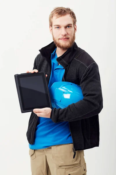 Construction and technology. Portrait of an unshaven young man showing you a digital tablet. — Stock Photo, Image