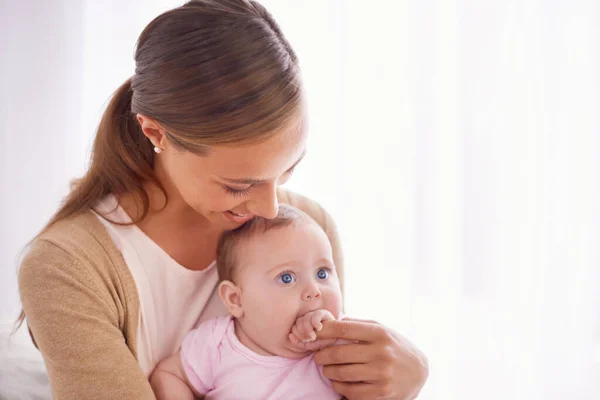 Whos the cutest baby of all. Shot of a young mother bonding with her baby girl. — Stock Photo, Image