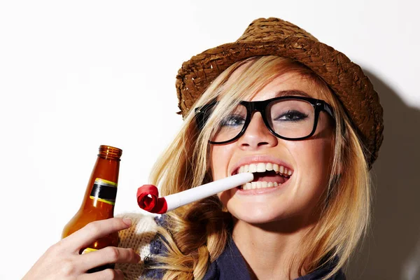 Nunca eres demasiado viejo para disfrutar de los favores de la fiesta. Una hermosa joven con un favor de fiesta en la boca sosteniendo una cerveza. — Foto de Stock