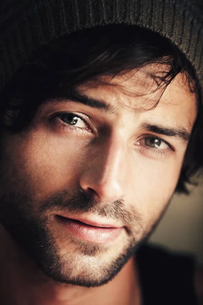 Hes any girls dream guy. Portrait of an attractive and ruggedly handsome man wearing a woolen cap. — Stock Photo, Image