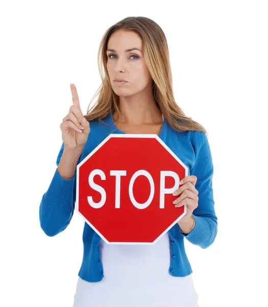 Read the sign. Studio portrait of a stern-looking woman holding a stop sign. — Stock Photo, Image