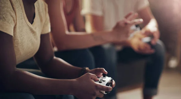 Im going to kick your butt at this game. Shot of a group of friends playing console games at home. — Stockfoto