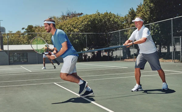 Die kracht opbouwen. Volledige opname van twee knappe sporters die resistente banden gebruiken tijdens een tennistraining overdag. — Stockfoto