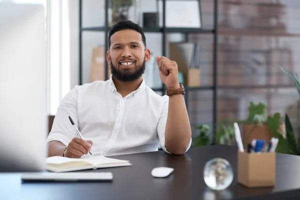 There are always plans to be made. Portrait of a young businessman writing notes in an office. — Stock Photo, Image