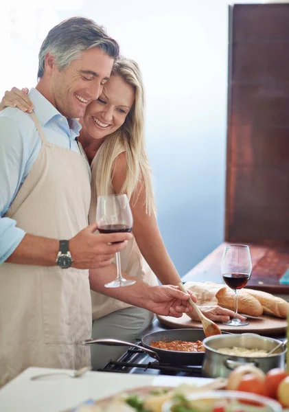 Hope you brought your appetite. Cropped shot of an affectionate couple cooking dinner. — Stock Photo, Image