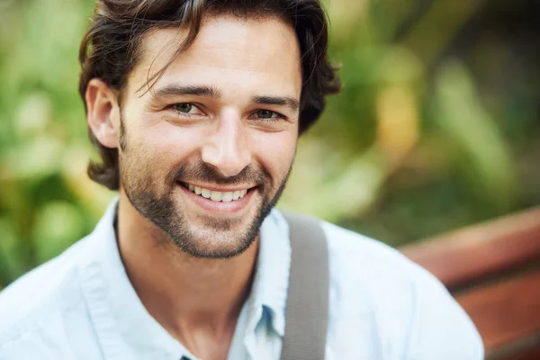 Live life to the fullest. Shot of a handsome young man in the park. — Stock Photo, Image