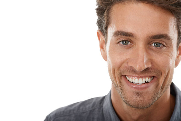 Hes so charismatic. Portrait of a handsome young man smiling against a white background.