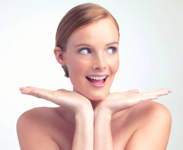 Completely gorgeous. A studio portrait of a beautiful young woman with her face in her hands. — Stock Photo, Image