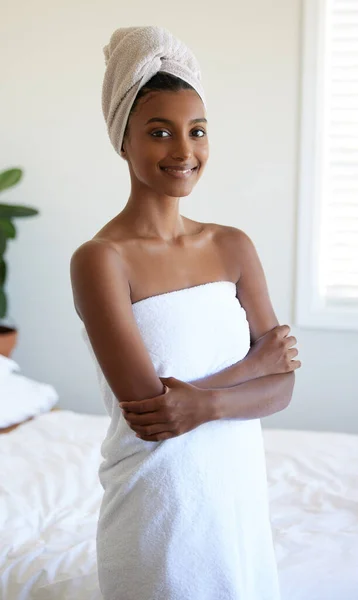 I feel so refreshed. Cropped portrait of an attractive young woman wrapped in a towel while standing with her arms folded in the bedroom. — Stock Photo, Image