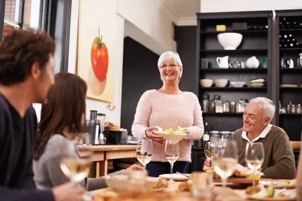 Friends and family are the true gifts in life. Shot of a family sitting down to dinner. — Stock Photo, Image