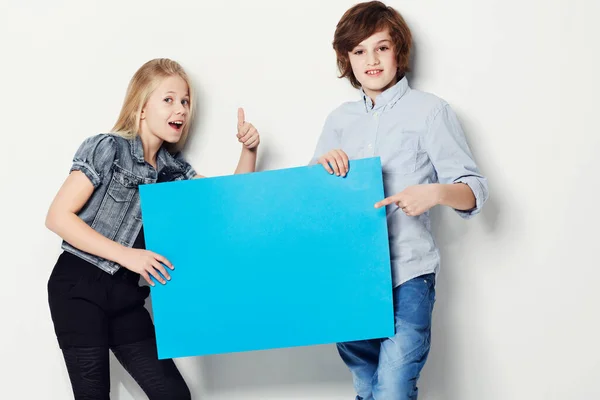 Heres the perfect answer. Shot of two young kids holding copy.space. — Stock Photo, Image