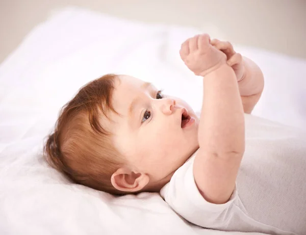 What are these things. A cropped shot of an adorable baby girl lying on a blanket. — Stock Photo, Image