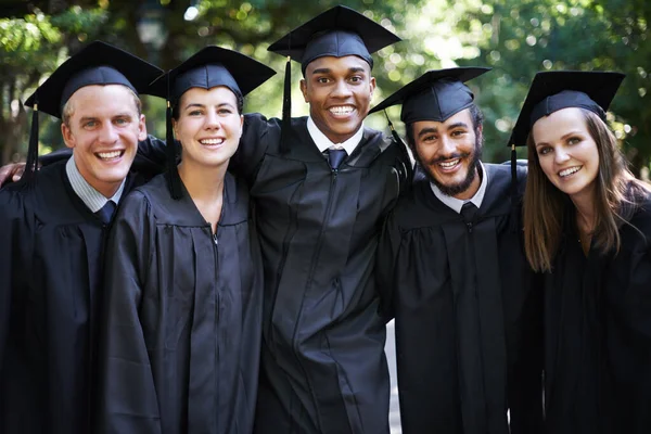 Ze zijn trots afgestudeerden. Groepsportret van enkele gelukkige studenten op afstudeerdag. — Stockfoto