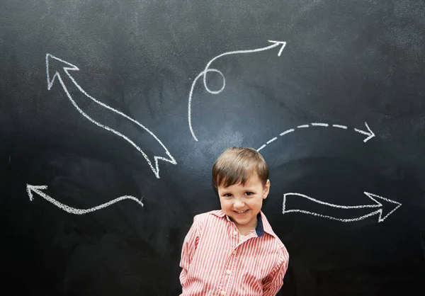 Drawing is so fun. Studio shot of an adorable little boy with chalk drawings behind him. — Stock Photo, Image