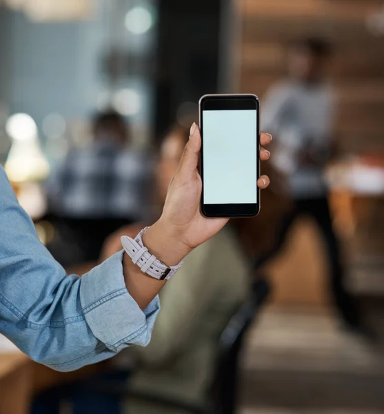 Υπάρχουν πολλές συνδέσεις για να βοηθήσει στην ενίσχυση της επιχείρησής σας. Κοντινό πλάνο μιας αγνώριστης επιχειρηματία που κρατάει ένα κινητό με μια λευκή οθόνη σε ένα γραφείο. — Φωτογραφία Αρχείου