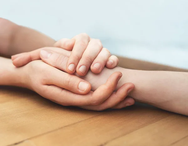 All will be fine. Cropped shot of two people holding hands in comfort.