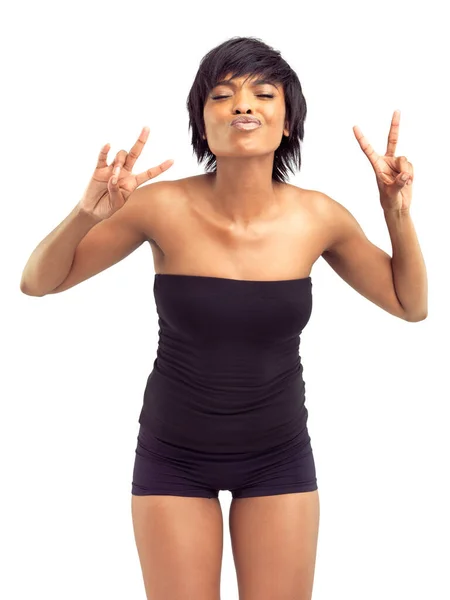 Peace and love to all my sisters out there. Beautiful smiling african woman in a white studio, making peace signs and a kissy-face. — Stock Photo, Image