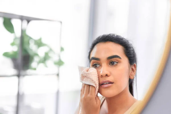 One thing youll never forget it taking care of your skin. Shot of a young woman drying her face with a towel at home. — Stock Photo, Image