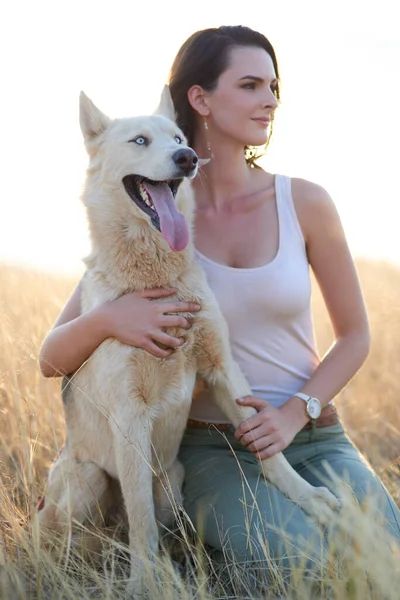 Les chiens vous montrent le sens de l'amour inconditionnel. Prise de vue d'une jeune femme séduisante collant avec son chien à l'extérieur. — Photo