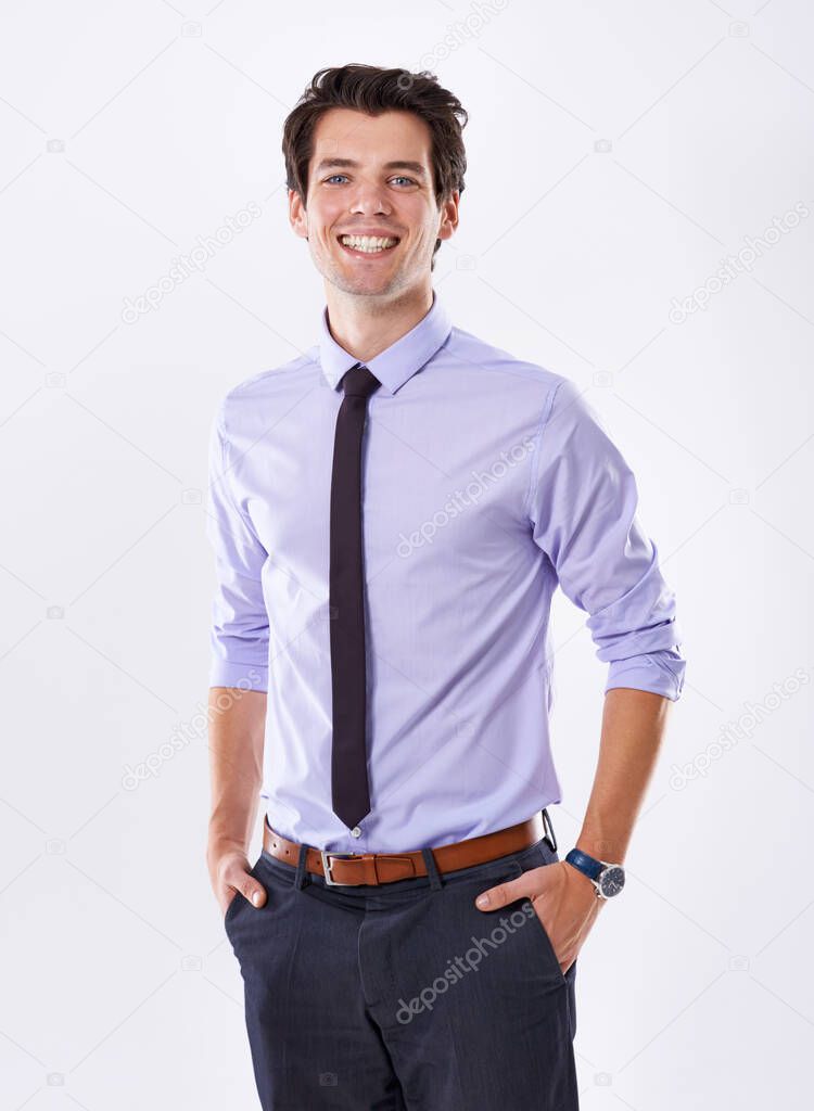 Business bravado. Studio shot of a handsome young businessman with his hands in his pockets against a white background.