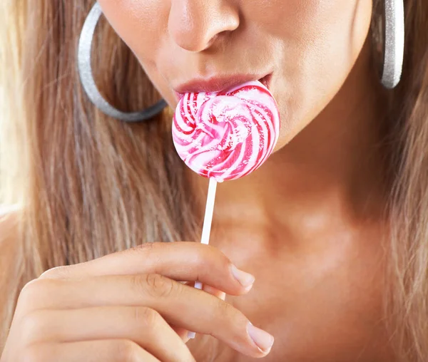 Candy girl. Closeup shot of a woman sucking a lollipop. Stock Picture