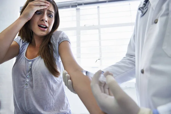 Dit doet geen pijn. Een arts die een vrouw een injectie geeft. — Stockfoto