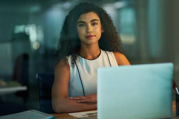 The hours are worth the rewards. Portrait of a confident young businesswoman working at her desk at night. — Stock Photo, Image