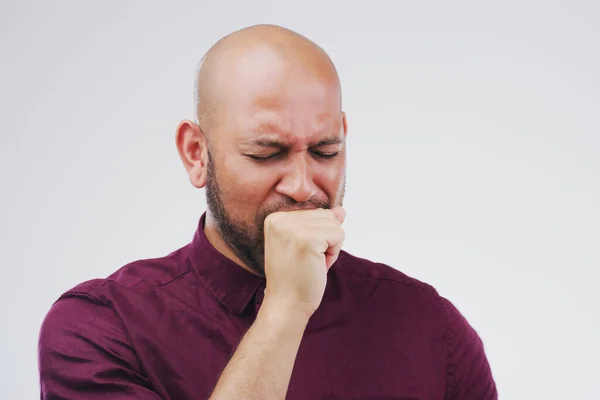 Bronchitis is not the best. Studio shot of a handsome young man coughing against a grey background. — Stock Photo, Image